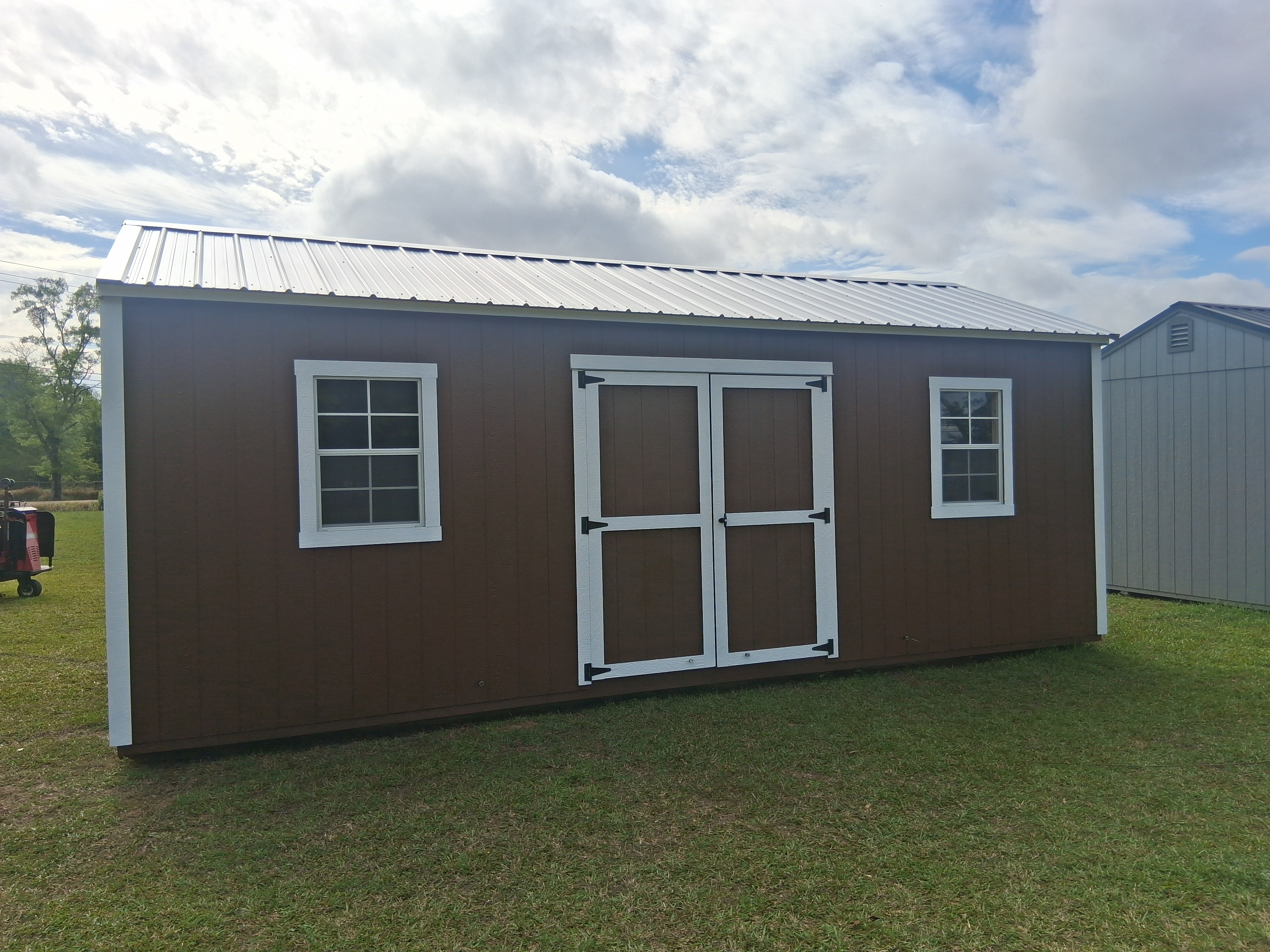 Custom portable building in a grassy yard