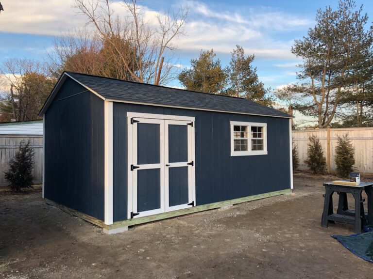 navy shed with 1 window and a double door